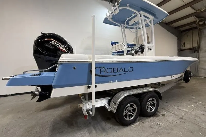 Slide: The Image of 2026 Robalo 226 Cayman boat on trailer in indoor storage facility. - 3
