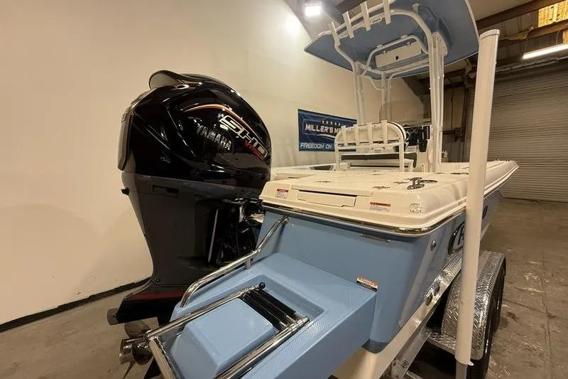 Slide: The Image of 2026 Robalo 226 Cayman boat with Yamaha engine in showroom setting. - 4