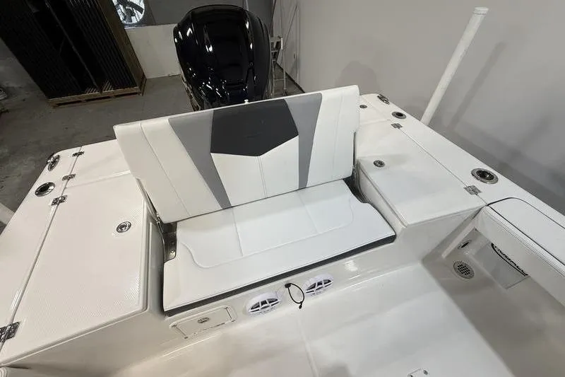 Slide: The Image of 2026 Robalo 226 Cayman boat interior with white seating and storage compartments. - 7
