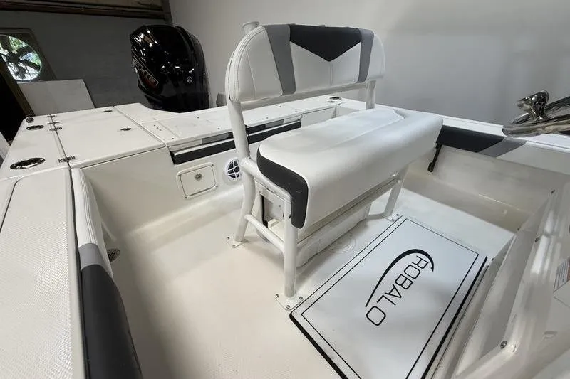 Slide: The Image of 2026 Robalo 226 Cayman boat interior with seating and storage compartments. - 8