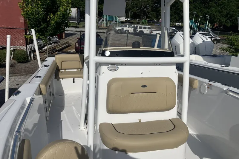 Slide: The Image of 2019 Sportsman Heritage 231 Center Console boat with beige seating and white console. - 10
