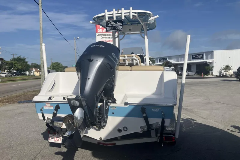 Slide: The Image of 2019 Sportsman Heritage 231 Center Console boat with powerful outboard motor, parked outdoors. - 5