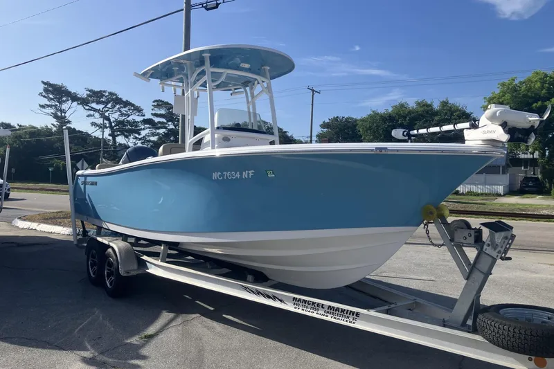 Slide: The Image of 2019 Sportsman Heritage 231 Center Console boat on trailer, parked outdoors. - 6