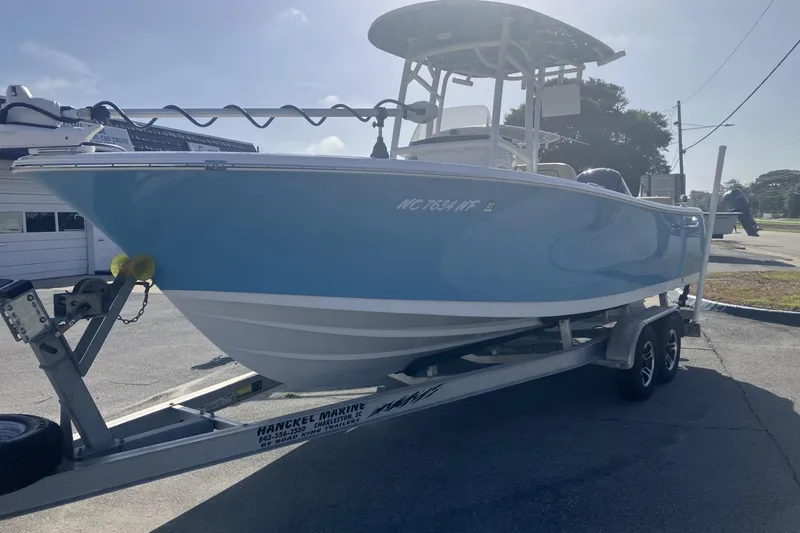 Slide: The Image of 2019 Sportsman Heritage 231 Center Console boat on trailer, parked outdoors. - 7