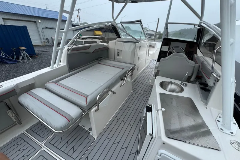 Slide: The Image of 2023 Solara S-250 DC boat interior with seating, steering, and kitchenette area. - 4