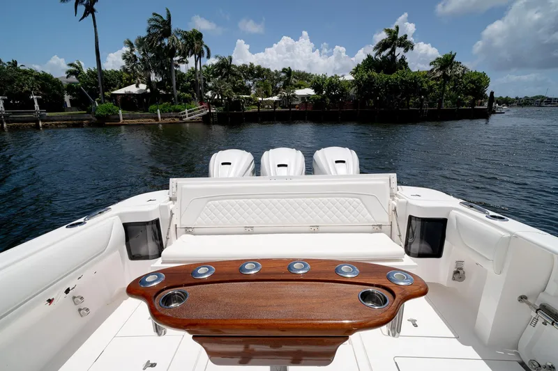 Slide: The Image of 2021 Intrepid 400 Center Console boat with luxurious seating and triple engines on a sunny day. - 11