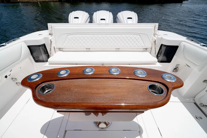 Slide: The Image of Luxurious 2021 Intrepid 400 Center Console boat interior with elegant wood table and seating. - 13
