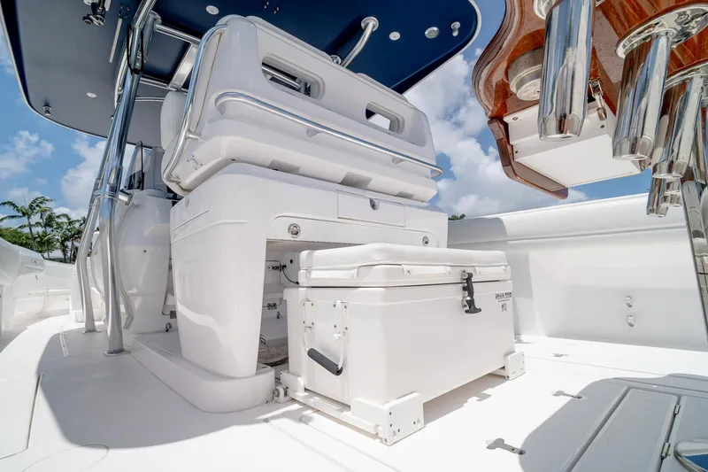 Slide: The Image of 2021 Intrepid 400 Center Console boat interior with seating and storage under a blue sky. - 18