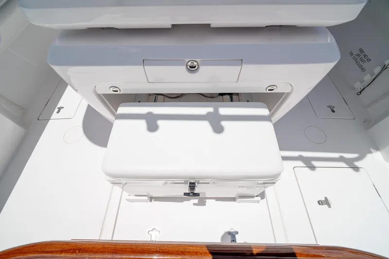 Slide: The Image of 2021 Intrepid 400 Center Console boat interior with white seating and storage compartments. - 19