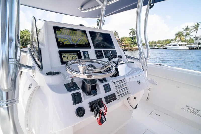 Slide: The Image of 2021 Intrepid 400 Center Console boat dashboard with navigation screens and steering wheel. - 22