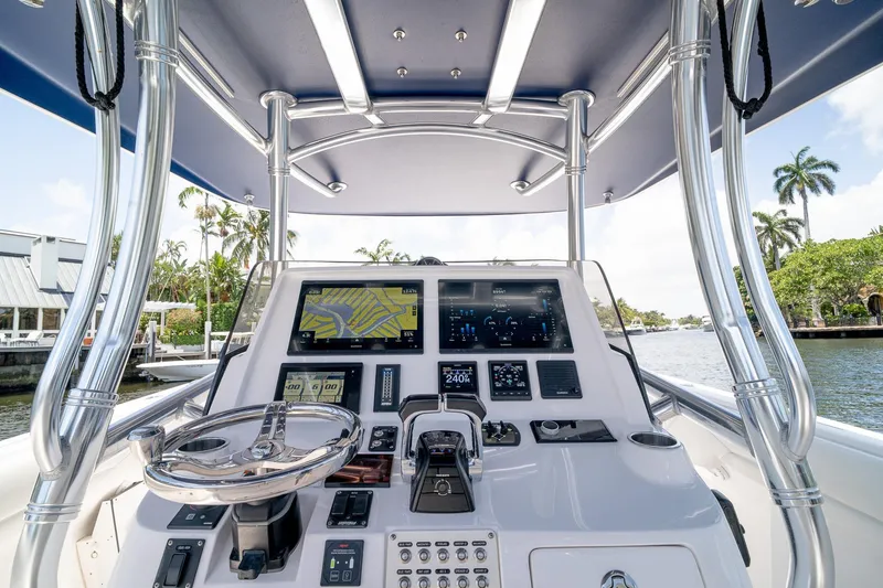 Slide: The Image of 2021 Intrepid 400 Center Console boat dashboard with navigation screens and steering wheel. - 24