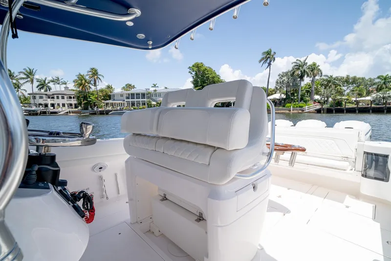 Slide: The Image of 2021 Intrepid 400 Center Console boat interior with luxurious seating and waterfront view. - 25