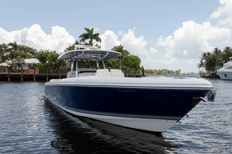 Slide: The Image of 2021 Intrepid 400 Center Console boat on calm water, surrounded by palm trees. - 3
