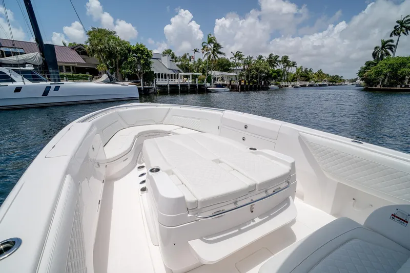 Slide: The Image of 2021 Intrepid 400 Center Console boat on a scenic waterway with lush greenery. - 36