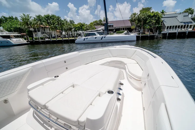 Slide: The Image of 2021 Intrepid 400 Center Console boat with spacious seating, docked near waterfront homes. - 39