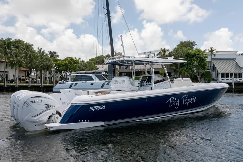 Slide: The Image of 2021 Intrepid 400 Center Console boat docked, featuring Yamaha engines and sleek design. - 4