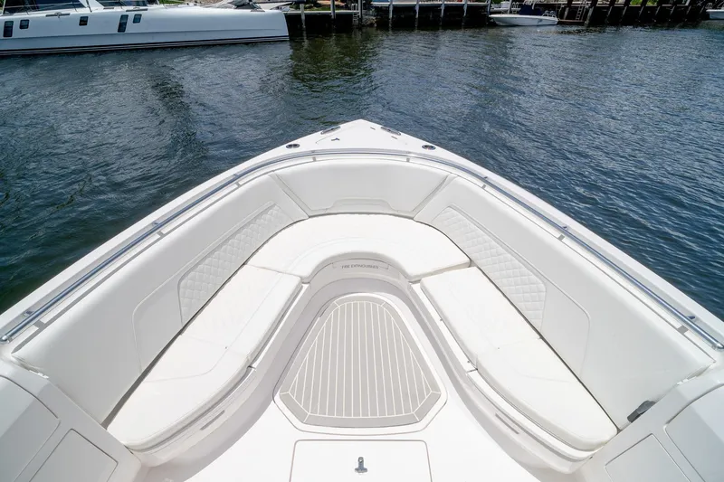 Slide: The Image of 2021 Intrepid 400 Center Console boat with spacious seating, docked by the water. - 40