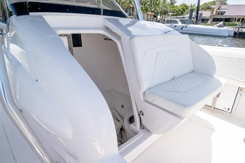Slide: The Image of 2021 Intrepid 400 Center Console boat interior with white seating and storage compartment. - 47