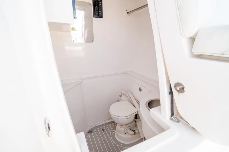 Slide: The Image of 2021 Intrepid 400 Center Console boat bathroom interior with toilet and sink. - 48