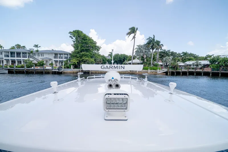 Slide: The Image of 2021 Intrepid 400 Center Console boat with Garmin equipment, docked near waterfront homes. - 49