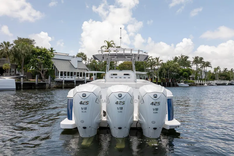 Slide: The Image of 2021 Intrepid 400 Center Console boat with triple Yamaha 425 V8 engines on a scenic waterway. - 5