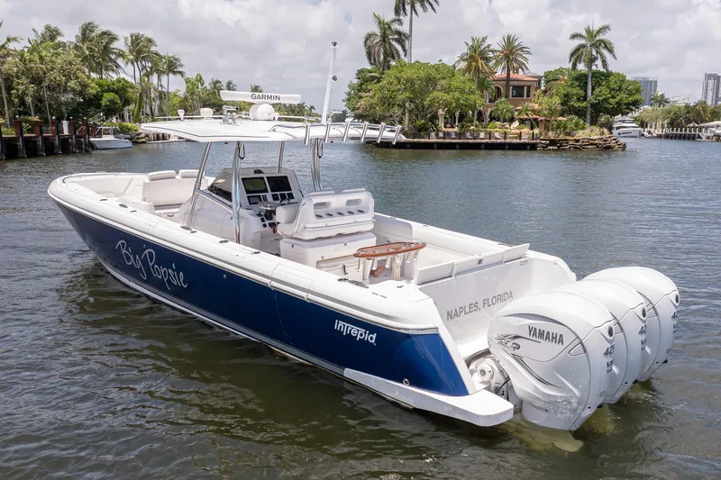 Slide: The Image of 2021 Intrepid 400 Center Console boat with Yamaha engines in a scenic waterway. - 9