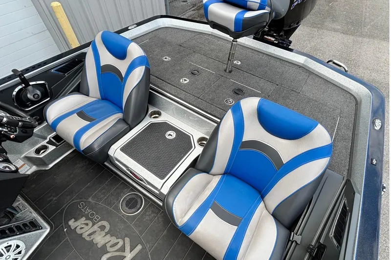 Slide: The Image of 2019 Ranger Z520L boat interior with blue and gray seats, steering wheel, and storage compartments. - 12