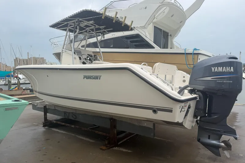 The Image of 2008 Pursuit C 230 Center Console boat with Yamaha outboard motor at marina. - 0