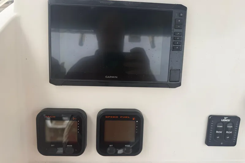 Slide: The Image of 2008 Pursuit C 230 Center Console dashboard with Garmin display and controls. - 12