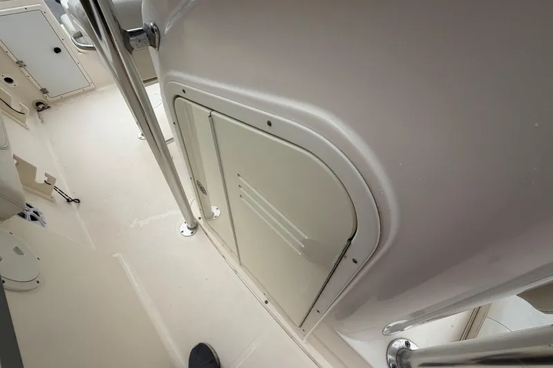 Slide: The Image of 2008 Pursuit C 230 Center Console interior with storage compartment and stainless steel railing. - 15