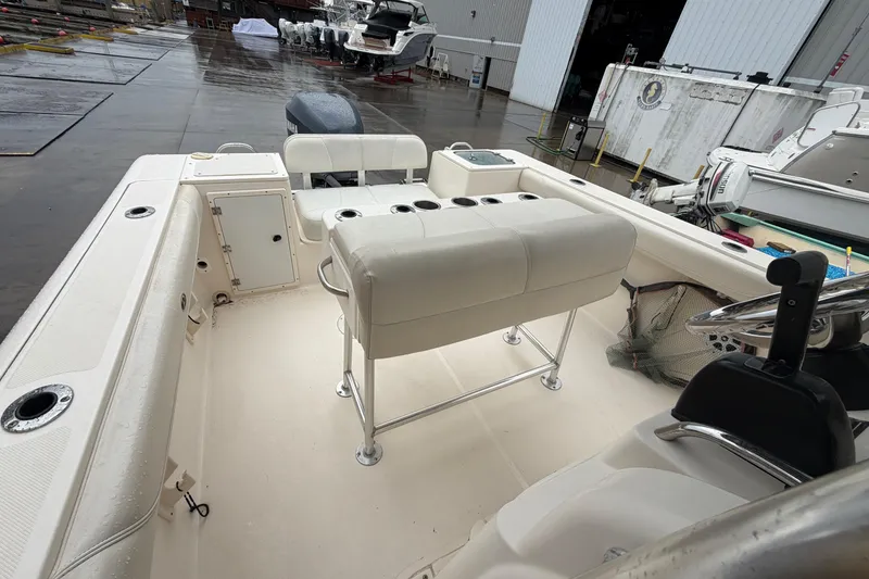 Slide: The Image of 2008 Pursuit C 230 Center Console boat interior with seating and storage compartments. - 16