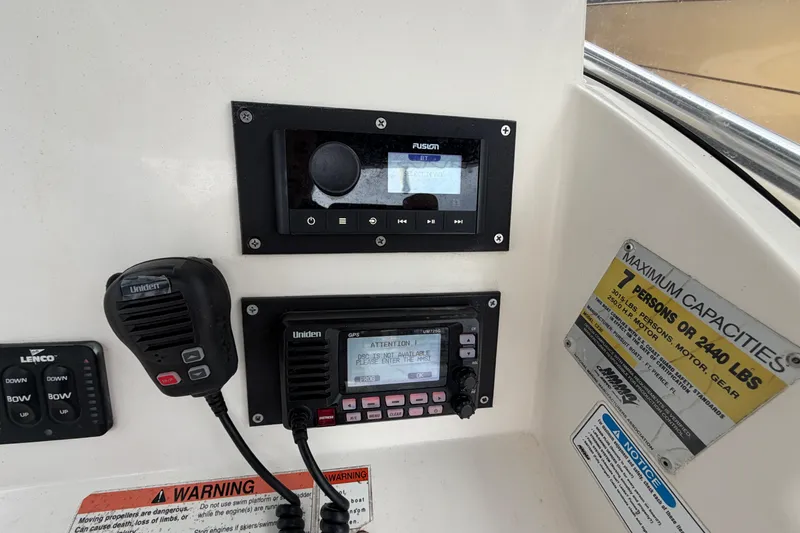 Slide: The Image of Console of 2008 Pursuit C 230 Center Console with radio and capacity warning labels. - 19