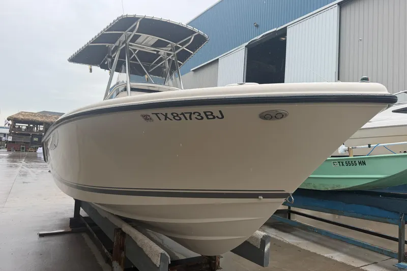 Slide: The Image of 2008 Pursuit C 230 Center Console boat on trailer in marina setting. - 2