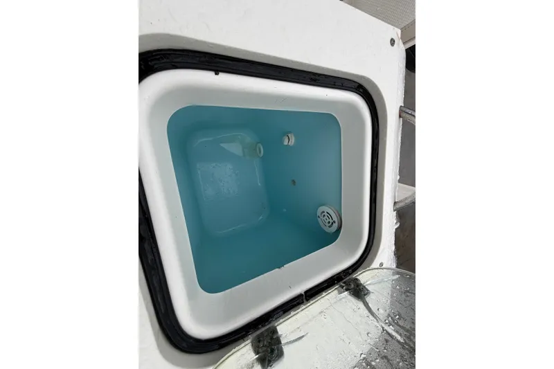 Slide: The Image of Livewell on a 2008 Pursuit C 230 Center Console boat, filled with water. - 25