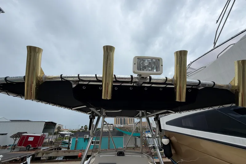 Slide: The Image of 2008 Pursuit C 230 Center Console boat with rod holders and spotlight on T-top. - 26