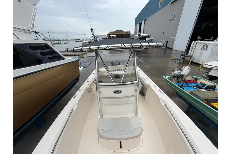 Slide: The Image of 2008 Pursuit C 230 Center Console boat docked at a marina, featuring a sleek design. - 29