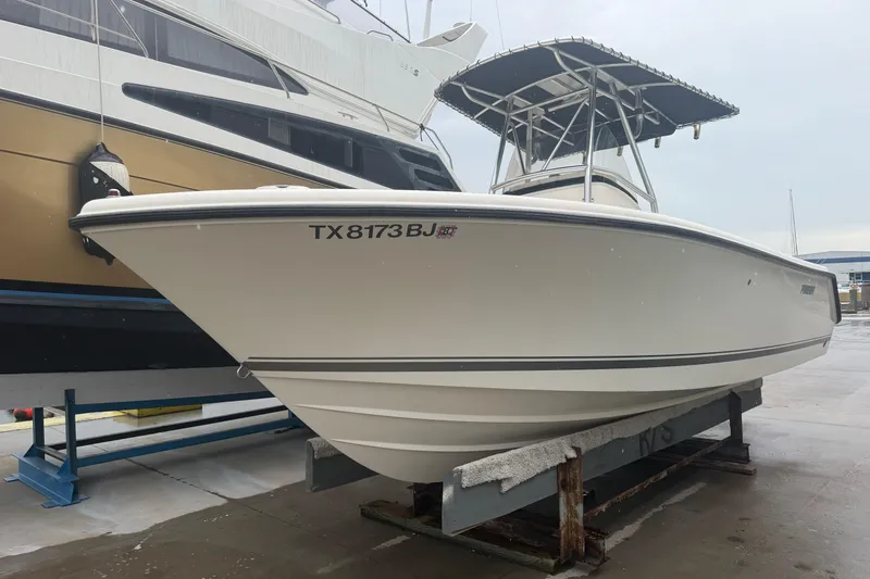 Slide: The Image of 2008 Pursuit C 230 Center Console boat on dock, side view. - 3