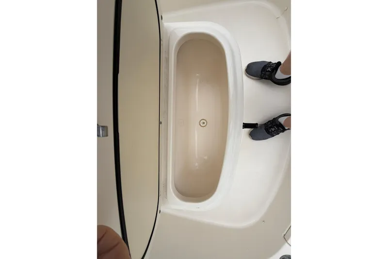 Slide: The Image of 2008 Pursuit C 230 Center Console boat interior with open storage compartment. - 30