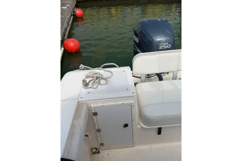 Slide: The Image of 2008 Pursuit C 230 Center Console boat with Yamaha 250 engine docked by red buoys. - 51