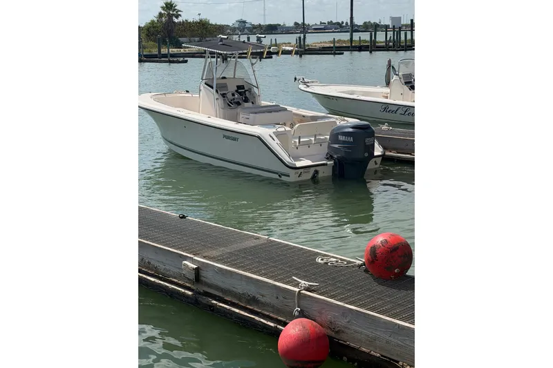 Slide: The Image of 2008 Pursuit C 230 Center Console boat docked with Yamaha outboard motor. - 53