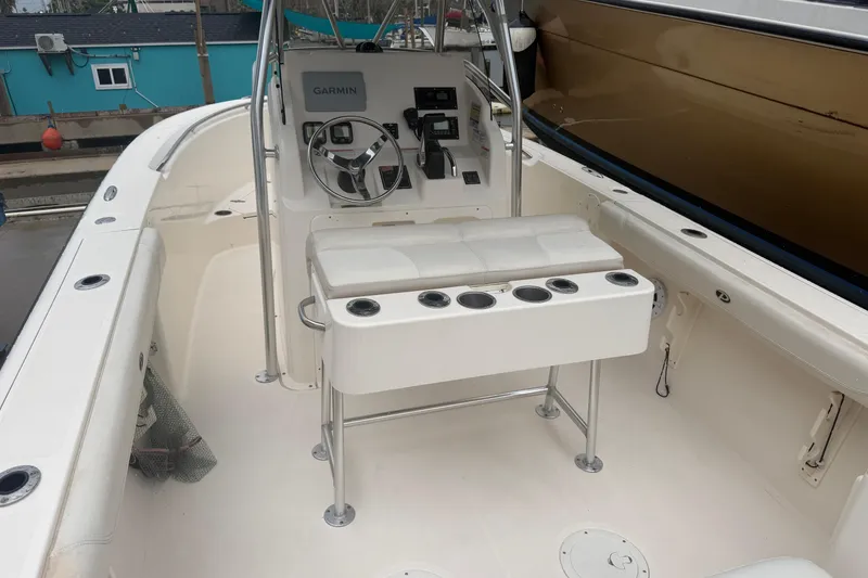 Slide: The Image of 2008 Pursuit C 230 Center Console boat interior with steering and seating area. - 6