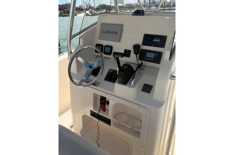 Slide: The Image of 2008 Pursuit C 230 Center Console boat dashboard with Garmin navigation system. - 44