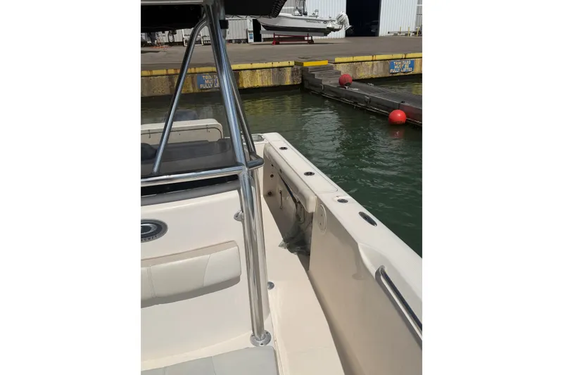 Slide: The Image of 2008 Pursuit C 230 Center Console boat docked at marina with red buoys. - 54