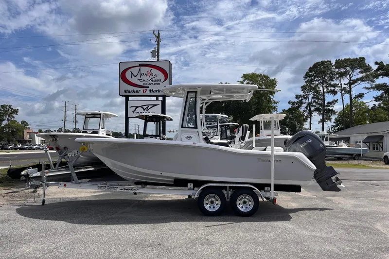The Image of 2026 Tidewater 210 LXF boat on trailer at dealership, under cloudy sky. - 0