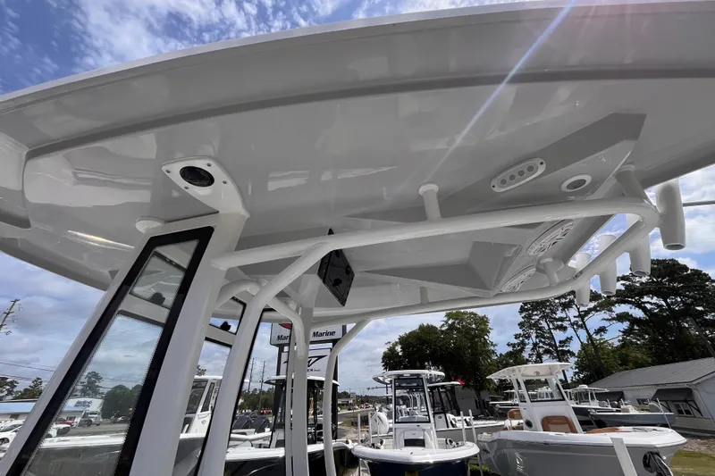 Slide: The Image of 2026 Tidewater 210 LXF boat with sleek design and modern features under a clear sky. - 13