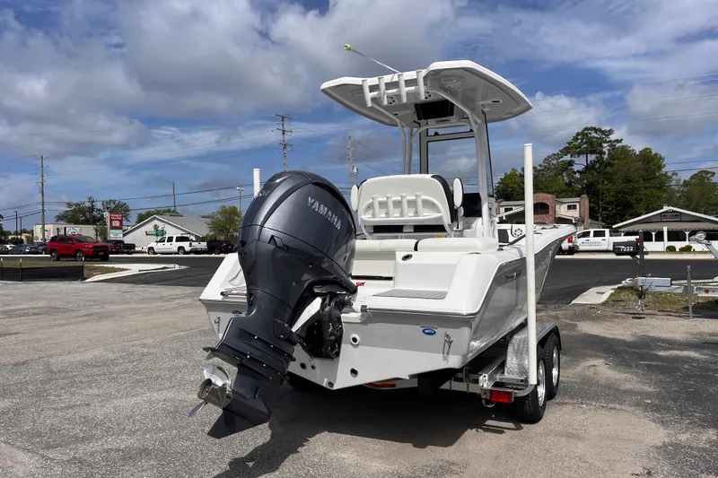 Slide: The Image of 2026 Tidewater 210 LXF boat with Yamaha outboard motor on trailer, parked outdoors. - 4