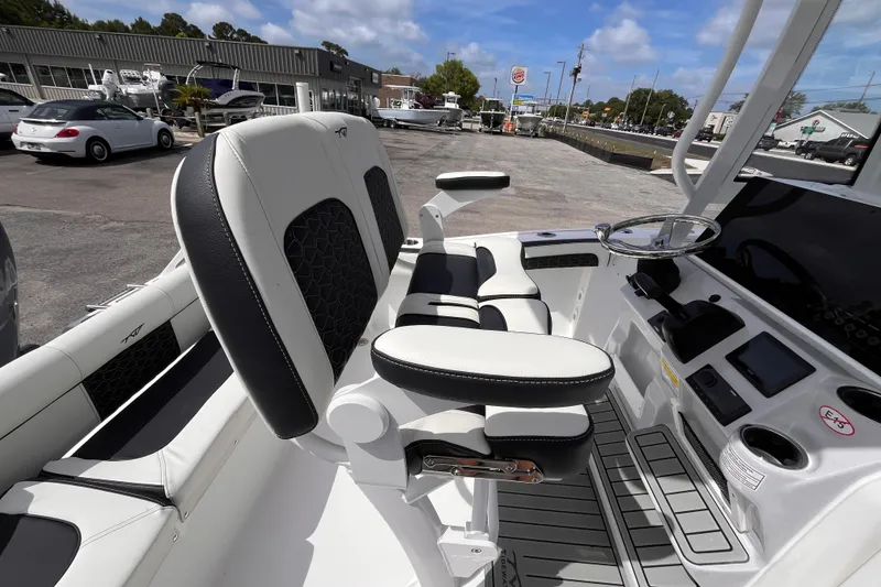 Slide: The Image of 2026 Tidewater 210 LXF boat interior with modern seating and steering console. - 6