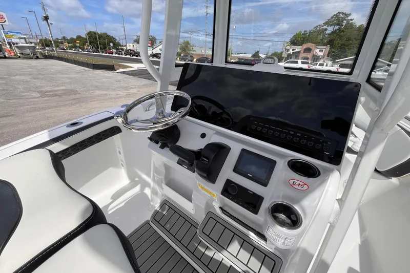 Slide: The Image of 2026 Tidewater 210 LXF boat dashboard with steering wheel and control panel. - 7