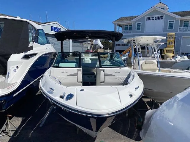 Slide: The Image of 2023 Sea Ray SLX 260 Outboard boat in harbor. - 21