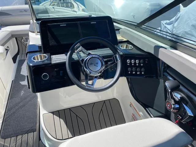 Slide: The Image of 2023 Sea Ray SLX 260 Outboard cockpit with modern steering and instruments. - 22